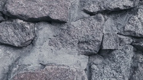 Smooth movement of the camera along the wall of the stone wall Stock Footage 113424500