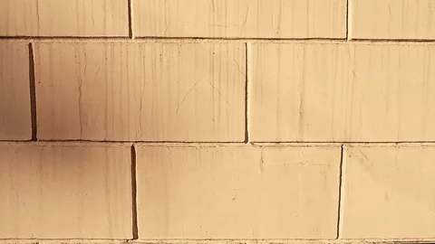 Smooth movement of the camera along the wall of large rectangular blocks Stock Footage 113424662