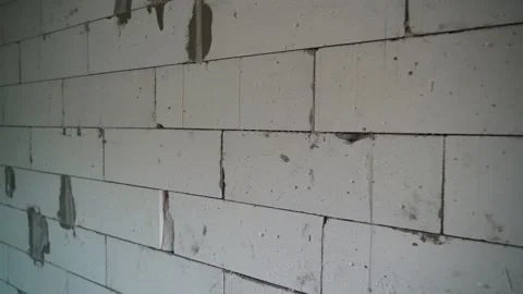 Smooth movement of the camera along the wall of aerated concrete block close-up Stock Footage 222950574