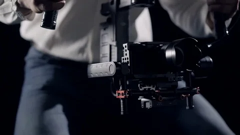 Smooth movement of the camera in the protective cage installed on the stabilizer Stock Footage