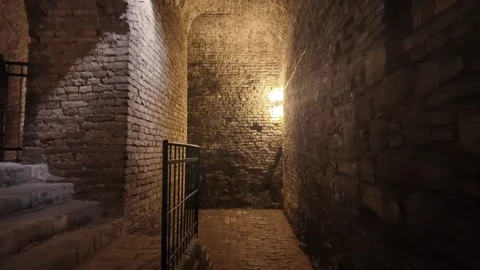 Smooth movement through ancient brick tunnels inside the underground catacombs Stock Footage 325742576