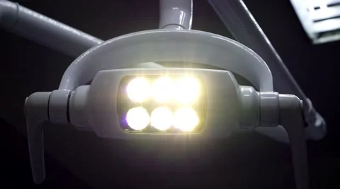 Smooth moving glowing medical shadowless lamp in the dental office Stock Footage 62564678