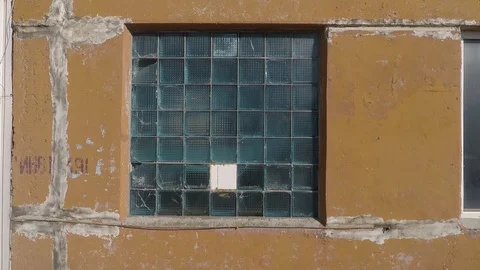 Smooth moving to the square window in the wall of glass blocks Stock-Footage 112764531