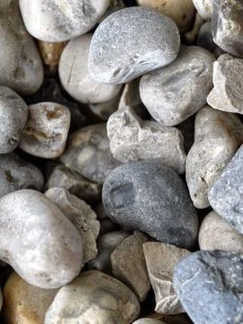 Smooth natural river pebbles background texture. Round sea rock stones top vi Stock-Fotos