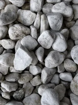 Smooth natural river pebbles background texture. Round sea rock stones top vi Stock Photos