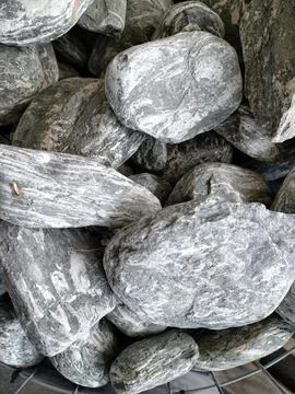 Smooth natural river pebbles background texture. Round sea rock stones top vi Stock Photos