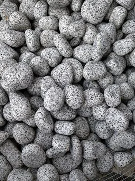 Smooth natural river pebbles background texture. Round sea rock stones top vi Stock Photos