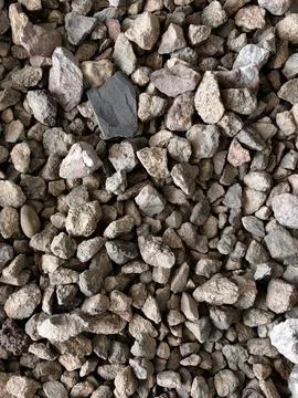 Smooth natural river pebbles background texture. Round sea rock stones top view Stock Photos