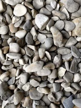 Smooth natural river pebbles background texture. Round sea rock stones top view Stock-Fotos