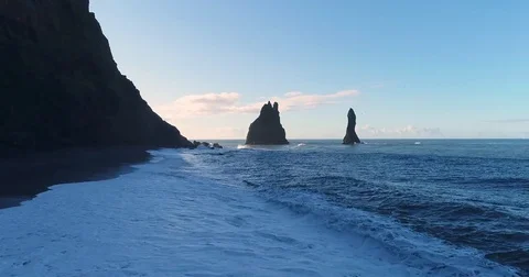 Smooth ocean aerial approaching basalt sea stacks in Iceland Video stock 79834250