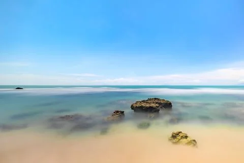 Smooth Ocean Waves Under a Vibrant Sky. Serene Ocean View with Gentle Waves. Stock Photos