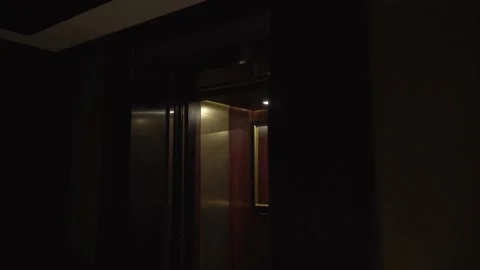 Smooth opening of empty elevator doors in the dark lobby. Stock Footage 189258088
