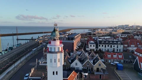 Smooth orbit around lighthouse rising toward sea horizon Stock Footage 331841982