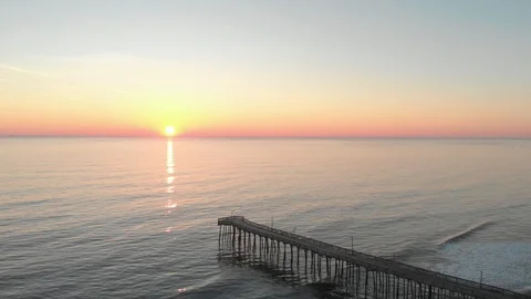 Smooth orbit over a pier during sunrise. Stock Footage 87523878