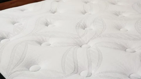 Smooth Pan Across White Fluffy Mattress Top Revealing Subtle Patterned Comfort Stock Footage 307377758