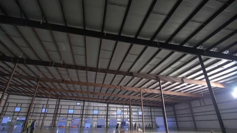 Smooth Pan Down of Construction Workers Working on Cement Floor Stock Footage 101390491