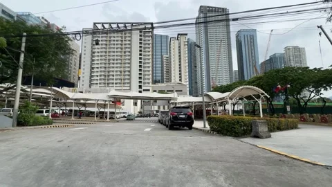 Smooth pan shot of a transit terminal and skyscrapers in Taguig 4K Stock Footage 337950997