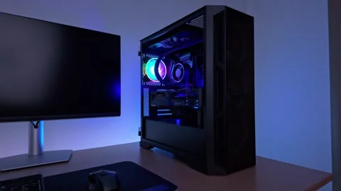 Smooth pan showcasing gaming desktop computer with illuminated case, balanc.. Stock Footage 328572360