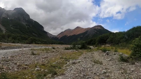 A smooth panorama pan view of a river with mountains and hills covered in snow Stock Footage 130644962