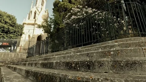 Smooth panoramic view of Calvario in Molfetta from a low angle near stone steps Stock Footage 315992356
