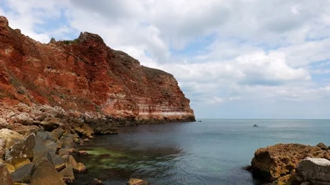 Smooth panoramic view of the vertical red cliffs and Bolata Beach Stock Footage 315414937