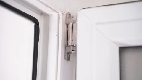 Smooth parallax around the upper door hinge of a white plastic door close-up Stock-Footage 228841652