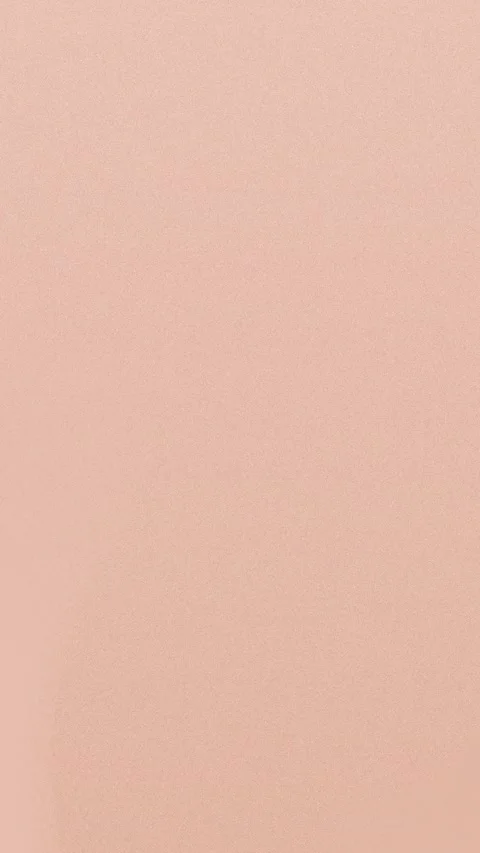 Smooth peach seamless loop background with fine grain texture. 4K Stock Footage 309856236