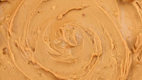 Smooth peanut butter texture circle rotation close up top view Stock Footage 274906340