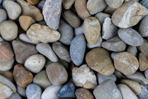 Smooth pebbles creating natural river outdoor background texture Stock Photos