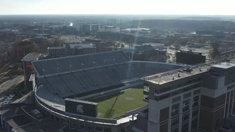 Smooth pullback aerial shot over Michigan State University’s Spartan Stadium Stock Footage 321795405