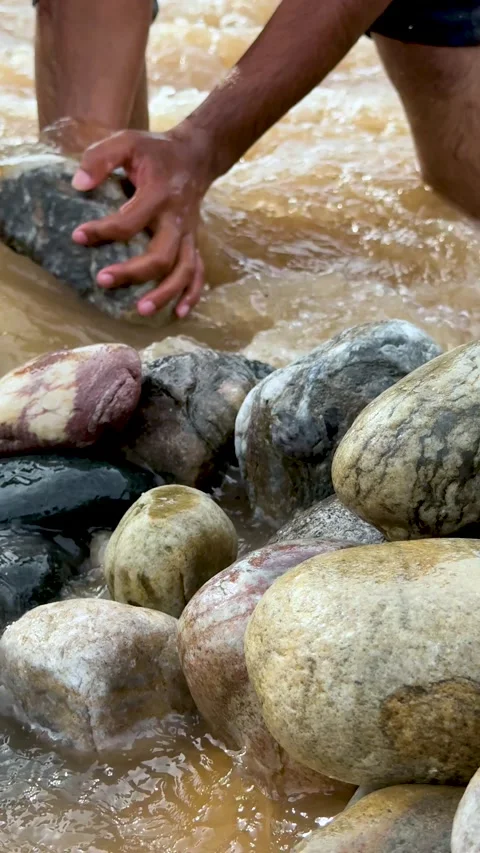 Smooth river stones with legs wading through flowing water creating a dynam.. Stock Footage 338414711