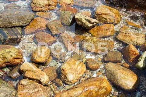 Smooth Rocks In Clear Ocean Water