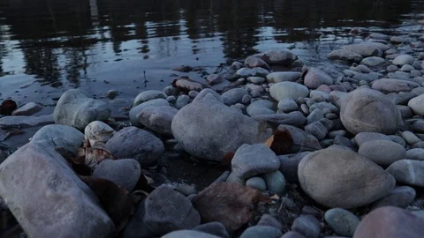 Smooth rocks on river shore Video stock 102730503