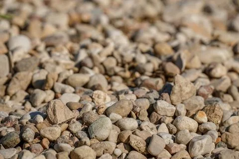 Smooth round beach pebbles background, natural texture closeup Stock Photos