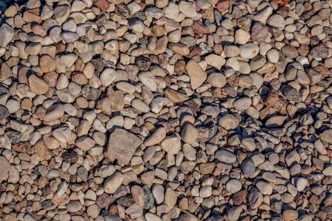 Smooth round pebbles background top view, natural texture Stock Photos