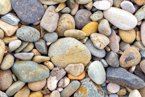 Smooth round pebbles sea texture background. Pebble on a beach. Gravel stone  Stock Photos