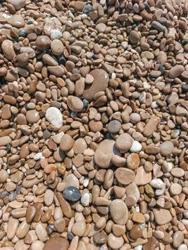 Smooth rounded sea pebbles on Cap d'Ail beach full frame texture Stock Photos