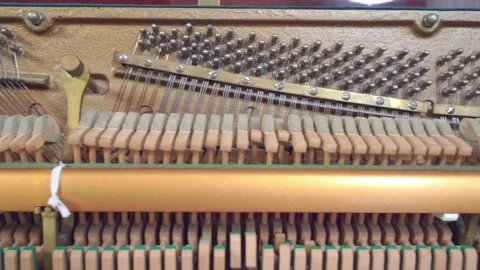 Smooth row of piano hammers synchronously move in wave from pressing the keys. Stock Footage 208222206