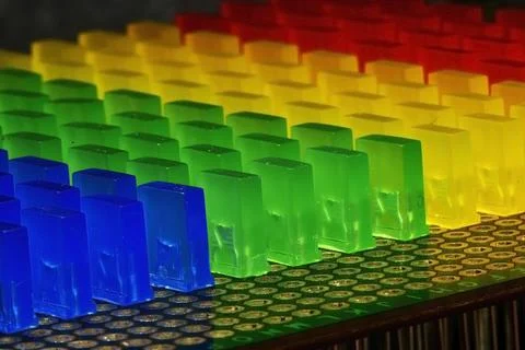 Smooth rows of multi-colored LEDs in pratik cases on a circuit board Stock Photos