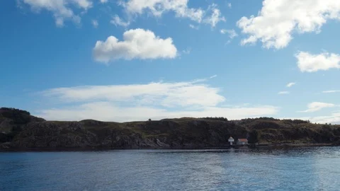 Smooth sea surface, hilly terrain in the background. Clear sky, beautiful Stock Footage 87562456