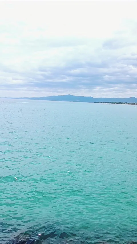 Smooth sea view with mountain background Stock Footage 282585770