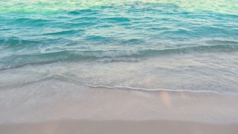 Smooth sea waves on the sand beach at sunny day. Turquoise water. 4K Stock Footage 119176195