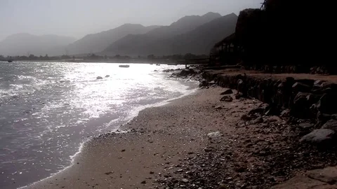 Smooth sea waves side view on beach sands with Sinai mounts background Stock Footage 71935189