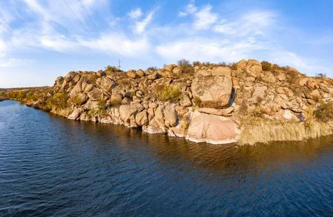 A smooth shining stream flows among large boulders Stock-Fotos