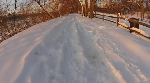 Smooth shot down snowy trail along river Stock Footage 40320067