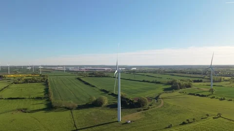 Smooth side drone approach to wind turbine over green countryside fields Stock Footage 333935347