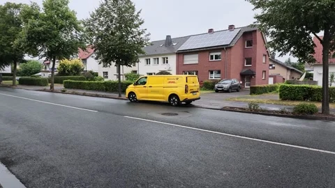 Smooth Side Tracking View of Parked Deutsche Post Van Stock Footage 345638950