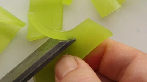 Smooth slicing of a piece of yellow soap with smooth texture and detailed Stock Footage 310565085