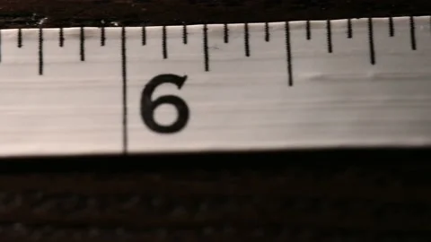 Smooth slide down the measuring tape 7 inches to 0 inches.  Tailor tape Vídeo Stock 169623378