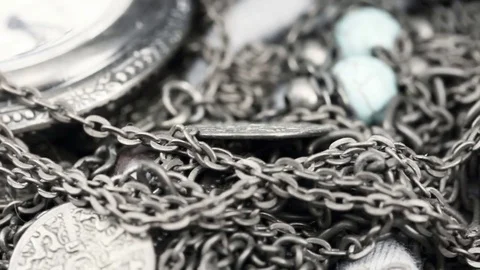 Smooth slide over antique watch, coins, bronze chains and gems handmade jewelry Stock Footage 72374396